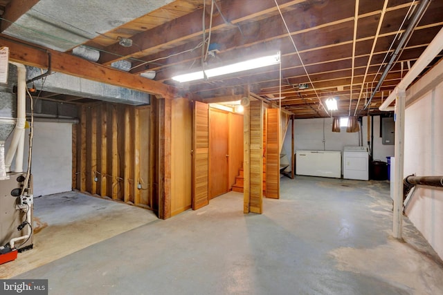 374 E Maple St, Dallastown, PA 17313 - unfinished below grade area with washer / clothes dryer, electric panel, stairway, and fridge