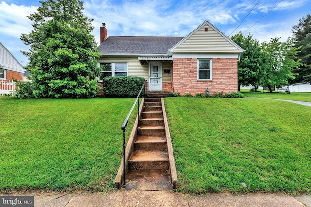 374 E Maple St, Dallastown, PA 17313 - bungalow-style house with a chimney, a front lawn, and roof with shingles