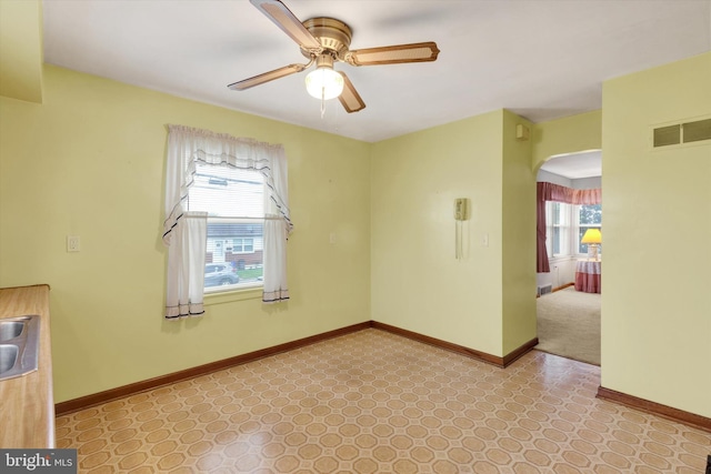 374 E Maple St, Dallastown, PA 17313 - spare room with a ceiling fan, arched walkways, and baseboards