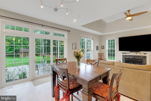 911 Echo Bay Ct, Gambrills, MD 21054 - dining space with a premium fireplace, ceiling fan, and a raised ceiling