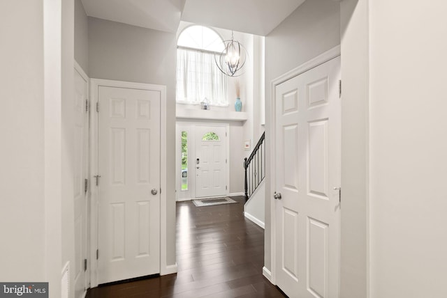 20355 Snowpoint Pl, Ashburn, VA 20147 - entryway with a chandelier, stairs, dark wood finished floors, and baseboards