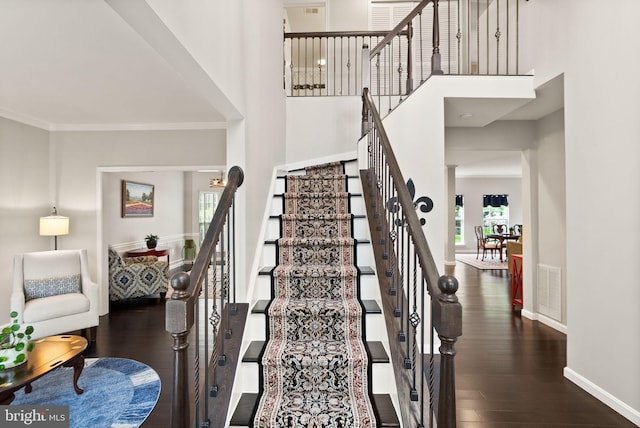 20355 Snowpoint Pl, Ashburn, VA 20147 - stairway with wood finished floors, baseboards, a high ceiling, and crown molding