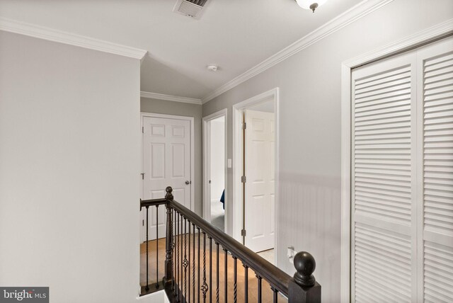 20355 Snowpoint Pl, Ashburn, VA 20147 - corridor featuring an upstairs landing, ornamental molding, a wainscoted wall, and wood finished floors