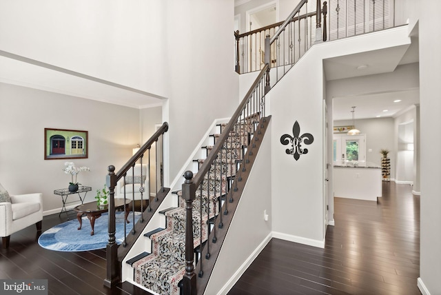 20355 Snowpoint Pl, Ashburn, VA 20147 - staircase featuring wood finished floors, a towering ceiling, baseboards, and recessed lighting