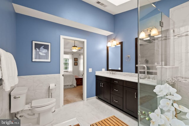 20355 Snowpoint Pl, Ashburn, VA 20147 - bathroom with double vanity, a stall shower, marble finish floors, a ceiling fan, and ensuite bath