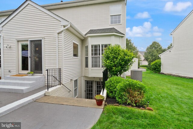 20355 Snowpoint Pl, Ashburn, VA 20147 - rear view of house featuring a yard, cooling unit, and a patio