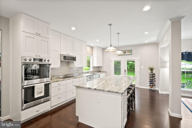 20355 Snowpoint Pl, Ashburn, VA 20147 - kitchen with appliances with stainless steel finishes, a center island, white cabinetry, dark wood-style floors, and recessed lighting