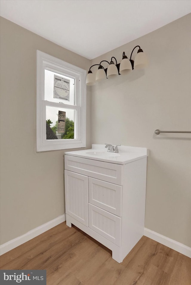 134 S Market St, New Cumberland, PA 17070 - bathroom featuring wood finished floors, baseboards, and vanity