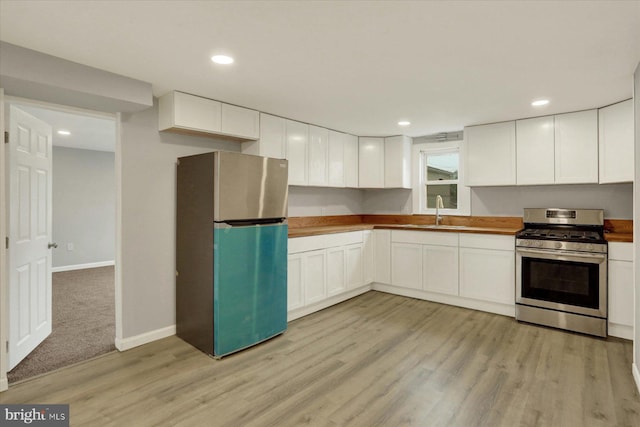 134 S Market St, New Cumberland, PA 17070 - kitchen with stainless steel appliances, light wood-type flooring, white cabinetry, a sink, and recessed lighting
