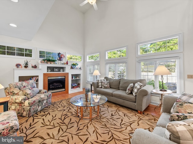 37 Sussex St, Rehoboth Beach, DE 19971 - living room with a towering ceiling, wood finished floors, a ceiling fan, a fireplace, and recessed lighting