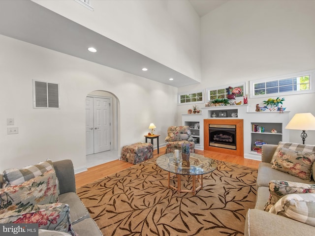 37 Sussex St, Rehoboth Beach, DE 19971 - living area with wood finished floors, arched walkways, a fireplace, recessed lighting, and baseboards