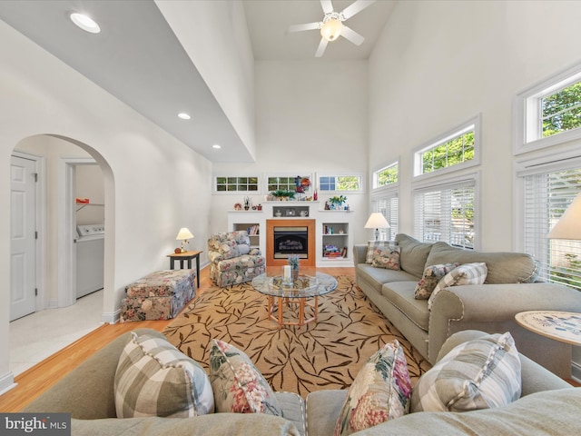 37 Sussex St, Rehoboth Beach, DE 19971 - living room with washer / dryer, arched walkways, wood finished floors, high vaulted ceiling, and a ceiling fan