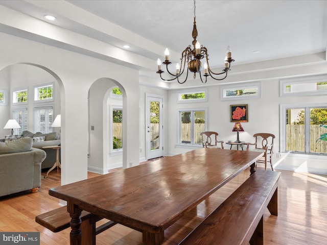 37 Sussex St, Rehoboth Beach, DE 19971 - dining room featuring arched walkways, a chandelier, recessed lighting, plenty of natural light, and light wood finished floors
