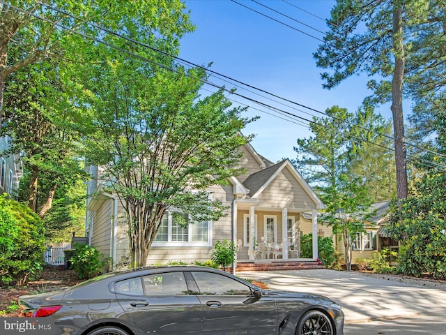 37 Sussex St, Rehoboth Beach, DE 19971 - view of property hidden behind natural elements featuring covered porch