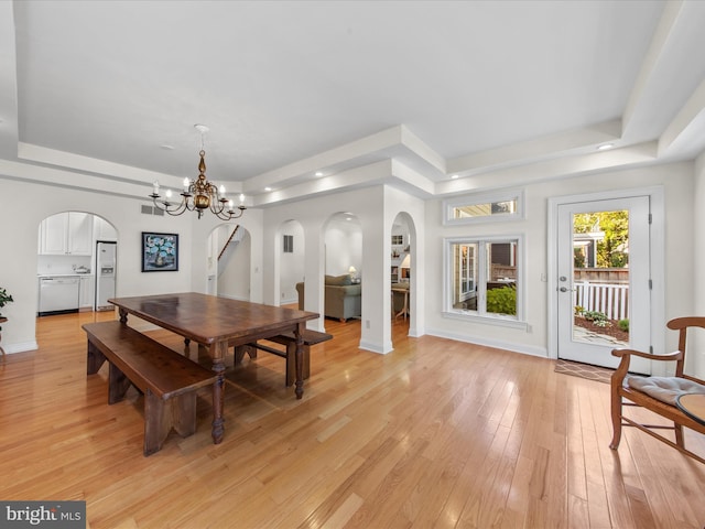 37 Sussex St, Rehoboth Beach, DE 19971 - dining room featuring a raised ceiling, arched walkways, baseboards, light wood-type flooring, and recessed lighting