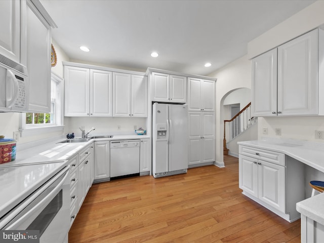 37 Sussex St, Rehoboth Beach, DE 19971 - kitchen with white appliances, white cabinets, light wood-style floors, and recessed lighting