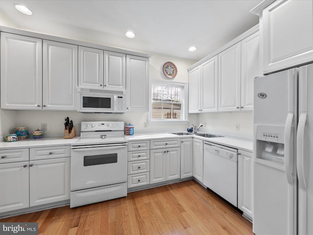 37 Sussex St, Rehoboth Beach, DE 19971 - kitchen featuring white appliances, a sink, white cabinetry, recessed lighting, and light countertops