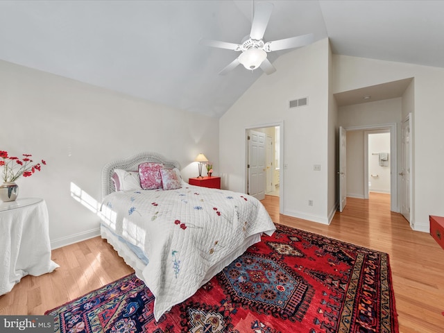 37 Sussex St, Rehoboth Beach, DE 19971 - bedroom with wood finished floors, baseboards, high vaulted ceiling, ensuite bath, and a ceiling fan