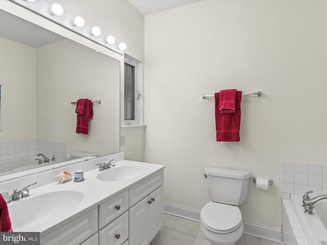 37 Sussex St, Rehoboth Beach, DE 19971 - full bathroom with double vanity, tile patterned floors, a garden tub, and baseboards