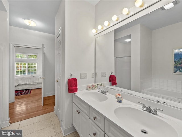 37 Sussex St, Rehoboth Beach, DE 19971 - bathroom featuring tile patterned flooring, a stall shower, double vanity, ensuite bath, and a bath