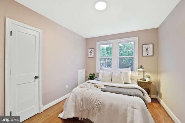 bedroom with baseboards and light wood-type flooring