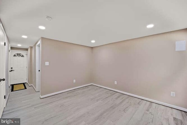 empty room with wood finished floors, baseboards, and recessed lighting