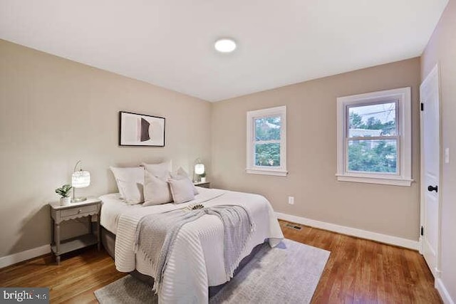 bedroom featuring baseboards and wood finished floors