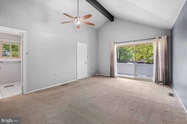 carpeted empty room with healthy amount of natural light, a ceiling fan, beam ceiling, high vaulted ceiling, and baseboards