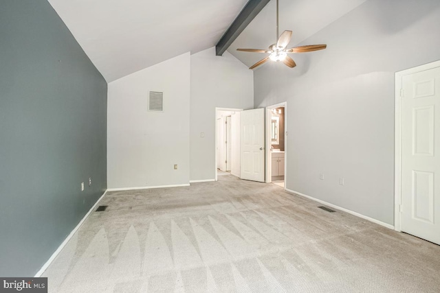 unfurnished bedroom featuring high vaulted ceiling, light colored carpet, beam ceiling, baseboards, and ensuite bathroom