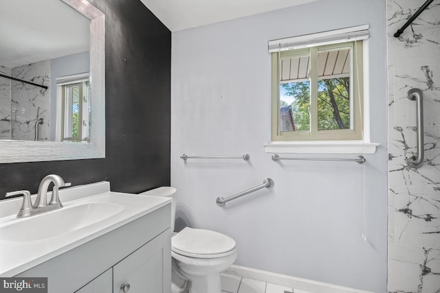 bathroom featuring a marble finish shower, vanity, and toilet