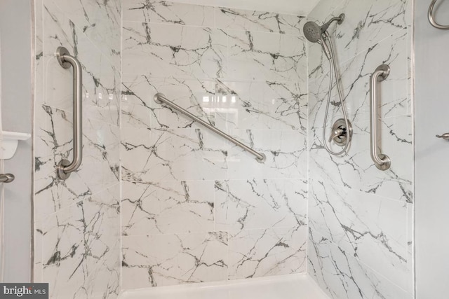 full bath with a marble finish shower