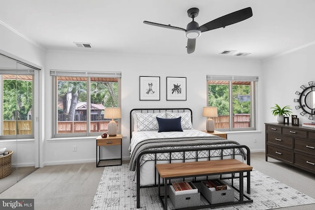 bedroom featuring crown molding, light colored carpet, baseboards, and ceiling fan