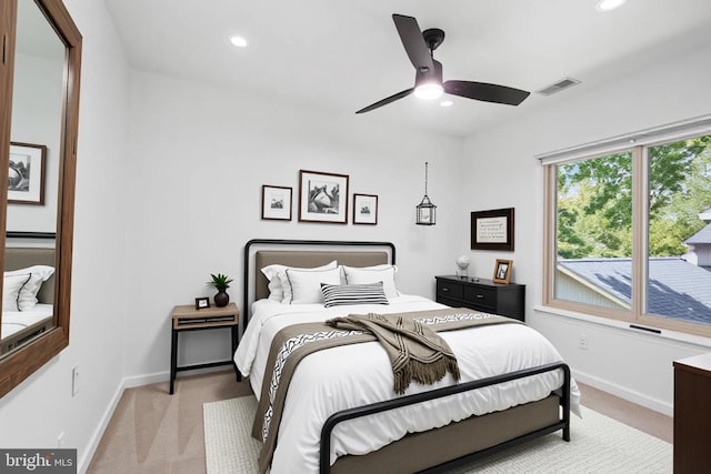 bedroom with light colored carpet, baseboards, recessed lighting, and a ceiling fan