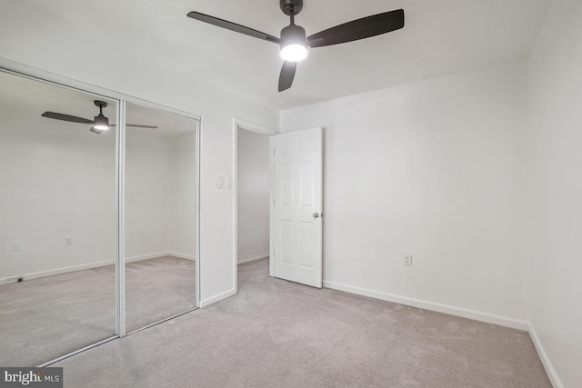 unfurnished bedroom with carpet flooring, a closet, ceiling fan, and baseboards