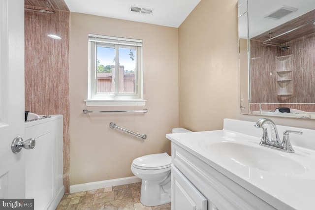 full bath with baseboards, toilet, vanity, and a shower