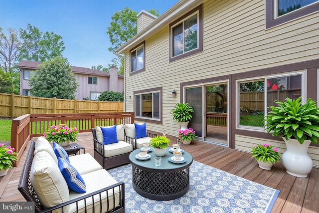 deck featuring an outdoor hangout area and fence