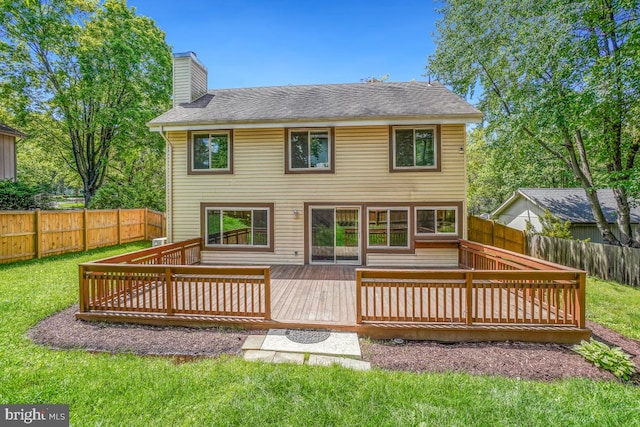 back of house featuring a chimney and a deck