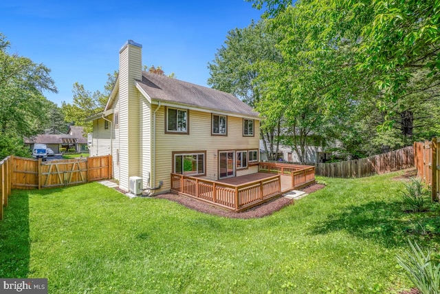 rear view of property with a deck, a chimney, and central AC