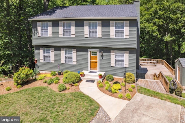 501 Macmillan Ct, Arnold, MD 21012 - colonial-style house featuring a chimney, a deck, and a front lawn