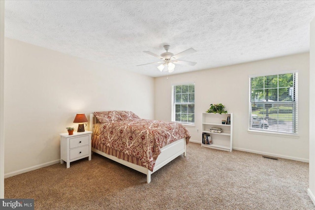 501 Macmillan Ct, Arnold, MD 21012 - bedroom featuring multiple windows, carpet floors, baseboards, a textured ceiling, and a ceiling fan