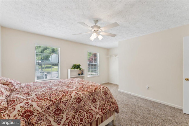 501 Macmillan Ct, Arnold, MD 21012 - carpeted bedroom featuring multiple windows, baseboards, a ceiling fan, and a textured ceiling