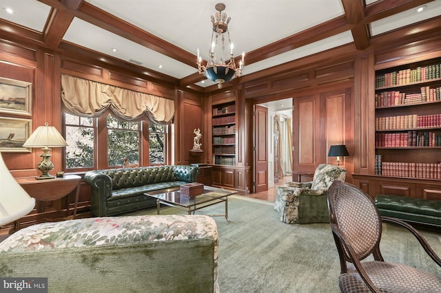 living area featuring built in shelves, a chandelier, coffered ceiling, beamed ceiling, and wooden walls