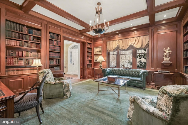 living area featuring built in features, beam ceiling, a chandelier, a decorative wall, and coffered ceiling