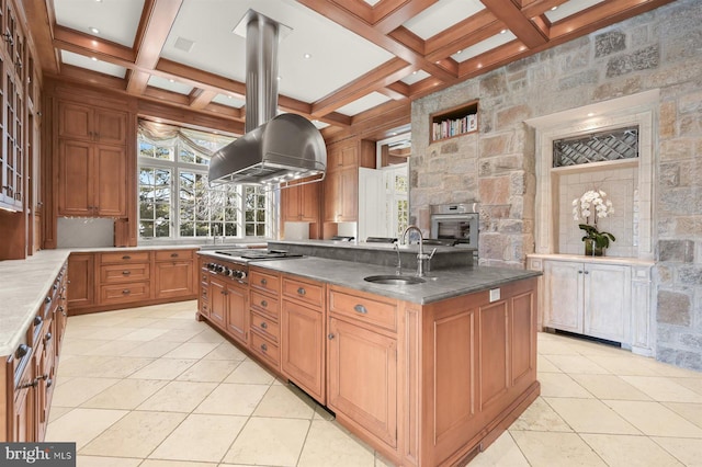 kitchen with a sink, appliances with stainless steel finishes, island range hood, coffered ceiling, and beamed ceiling