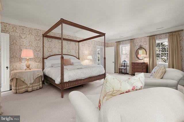 carpeted bedroom with wallpapered walls and ornamental molding