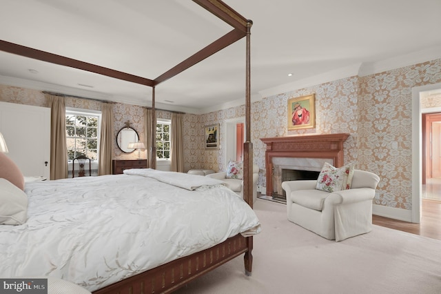 bedroom with ornamental molding, wallpapered walls, a fireplace, and baseboards