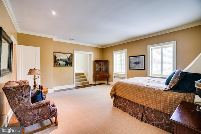 bedroom featuring radiator heating unit, crown molding, light carpet, and baseboards
