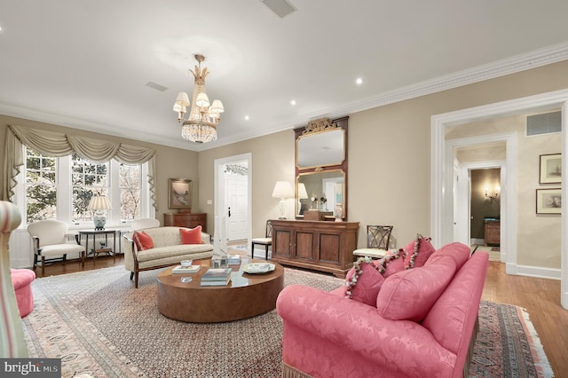 living room featuring light wood finished floors, a chandelier, crown molding, baseboards, and recessed lighting