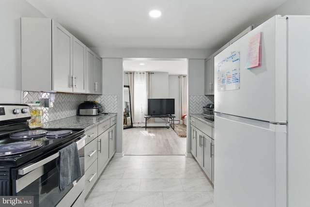 4508 Post Rd, Marcus Hook, PA 19061 - kitchen with freestanding refrigerator, stainless steel range with electric cooktop, tasteful backsplash, recessed lighting, and light marble finish flooring