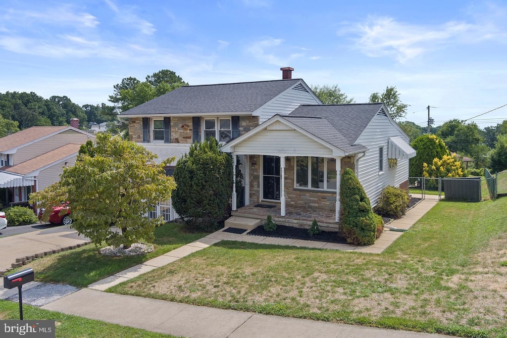 9217 Orbitan Rd, Parkville, MD 21234 - view of front of house with stone siding, a shingled roof, and a chimney